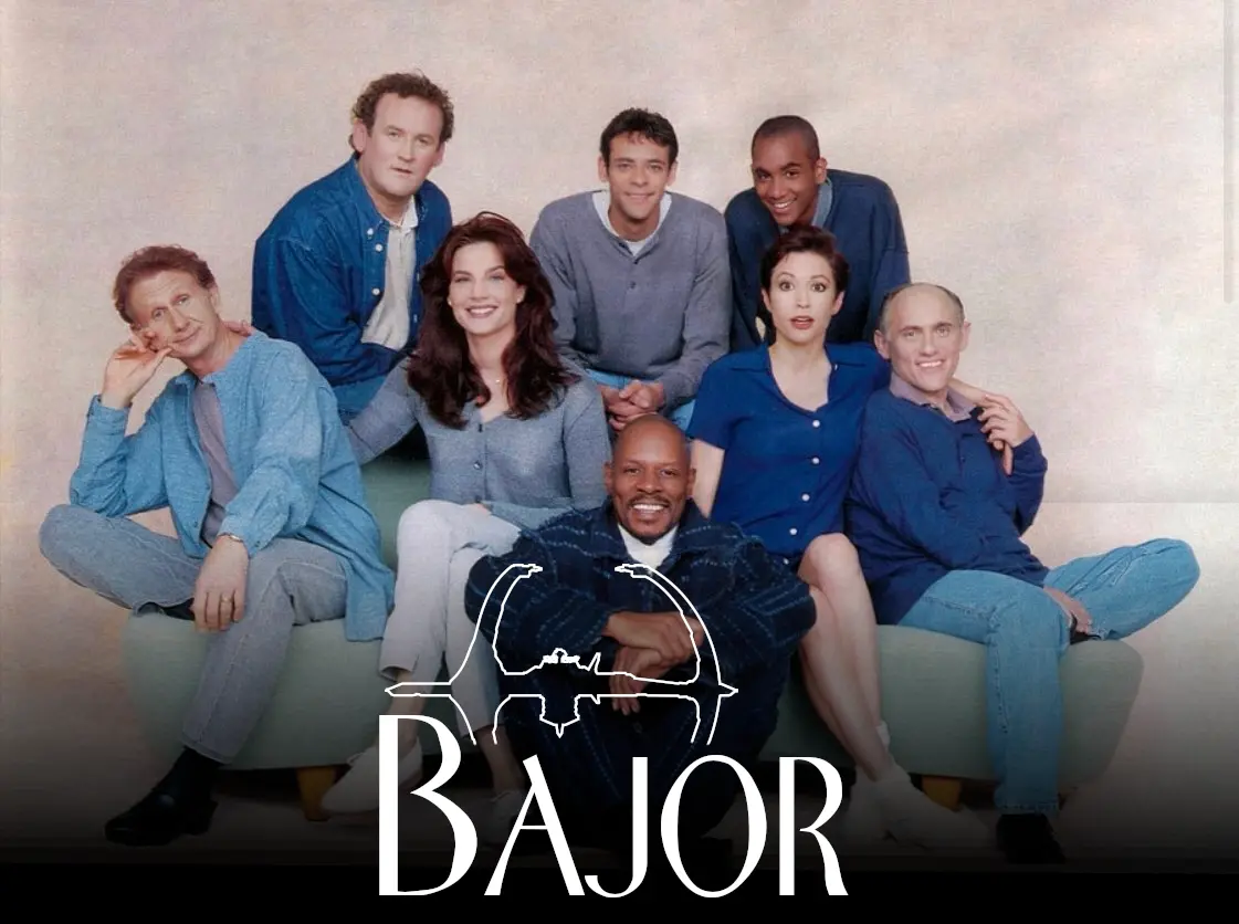 The cast of Star Trek: Deep Space Nine out of costume in casual clothes posing for a photo together, giving a very sitcom vibe. Over them is a logo reading “Bajor” in the style of the Frasier logo with a silhouette of Deep Space Nine in place of the Seattle skyline.