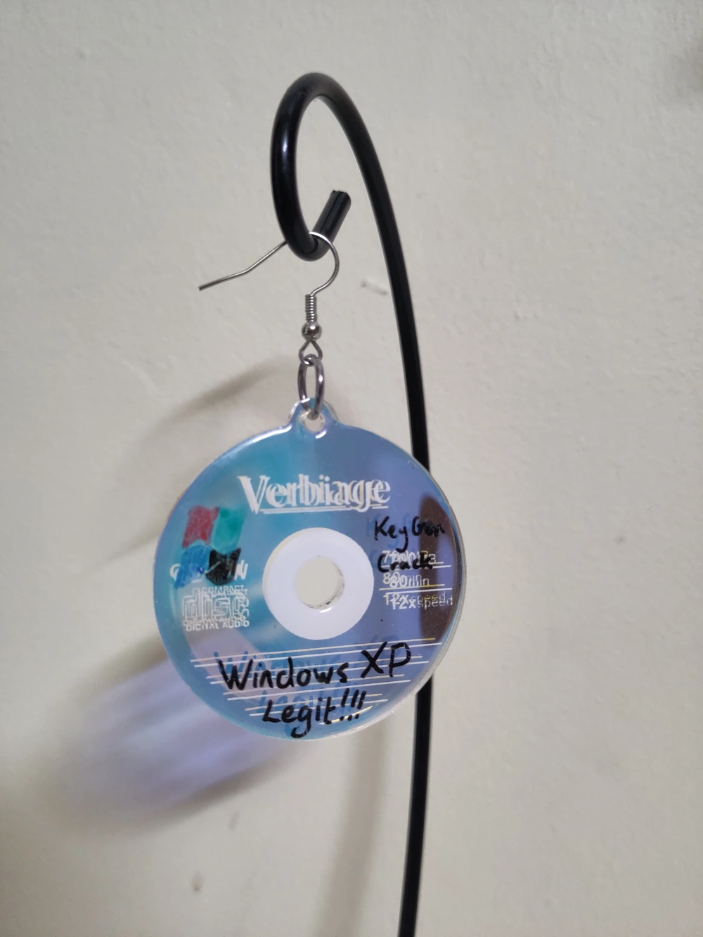 A mini CD labelled “Verbiage” with “Windows XP Legit” written on it with marker.