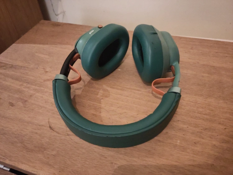 My Fairbuds XL 2023, mostly green but with one side in black.