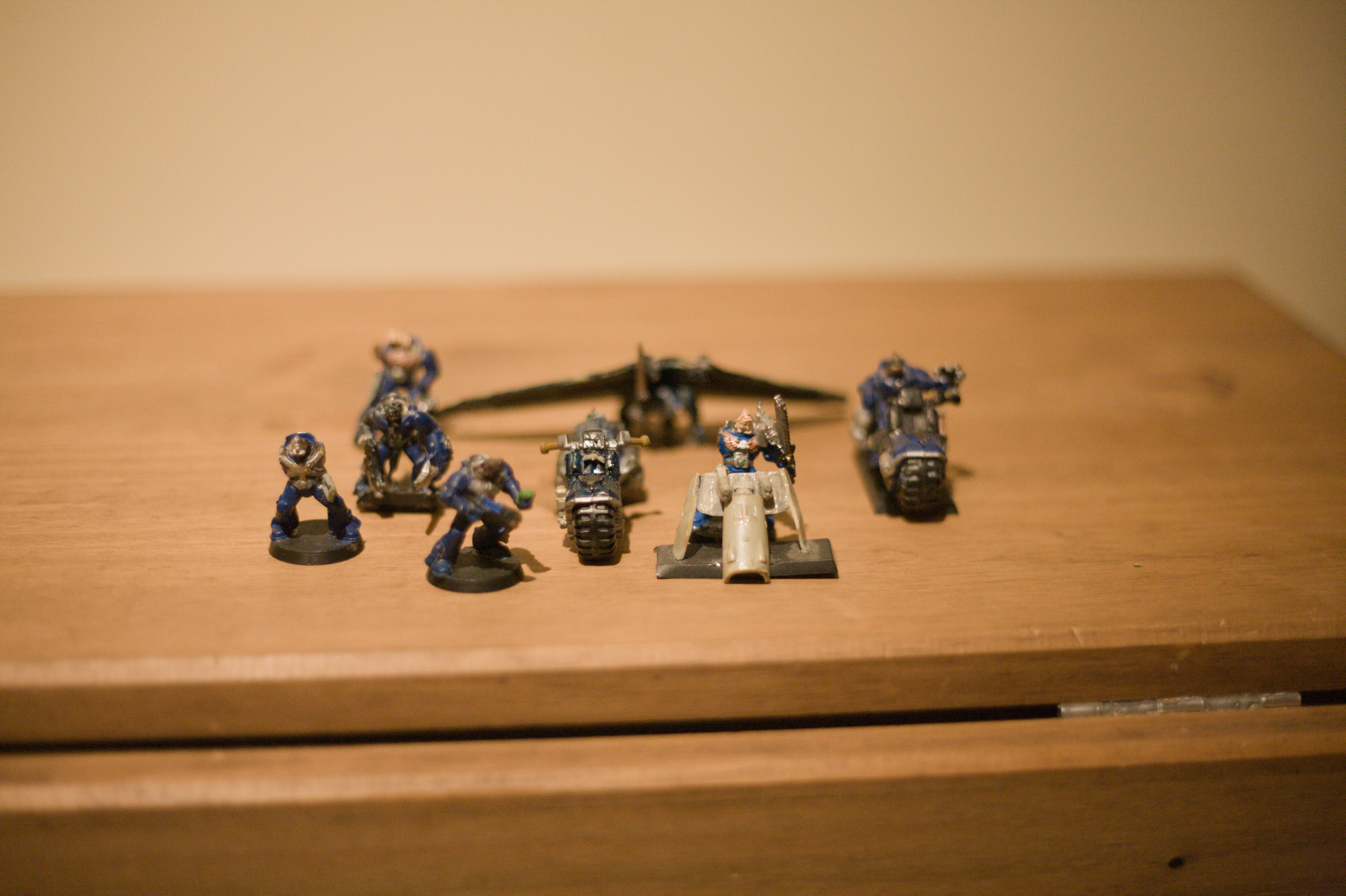 A different set of rat men, this time in crudely painted blue power armour and two motorbikes and a hang glider in the background out of focus. These ones are painted but much more damaged.