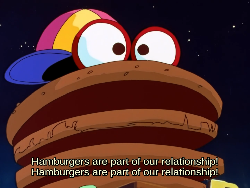 A still from Dirty Pair with the subtitles of the couple singing “Hamburgers are part of our relationship!”