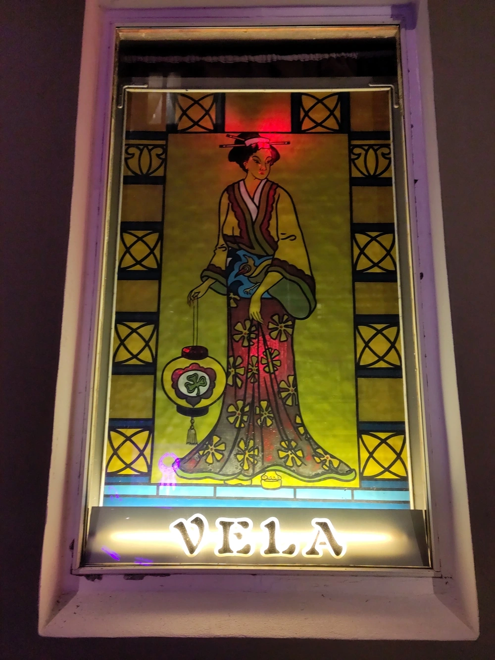 A stained glass window of a woman in a kimono.